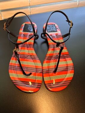 Tory Burch Emmy T-Strap flat sandals featuring a striped patent leather design